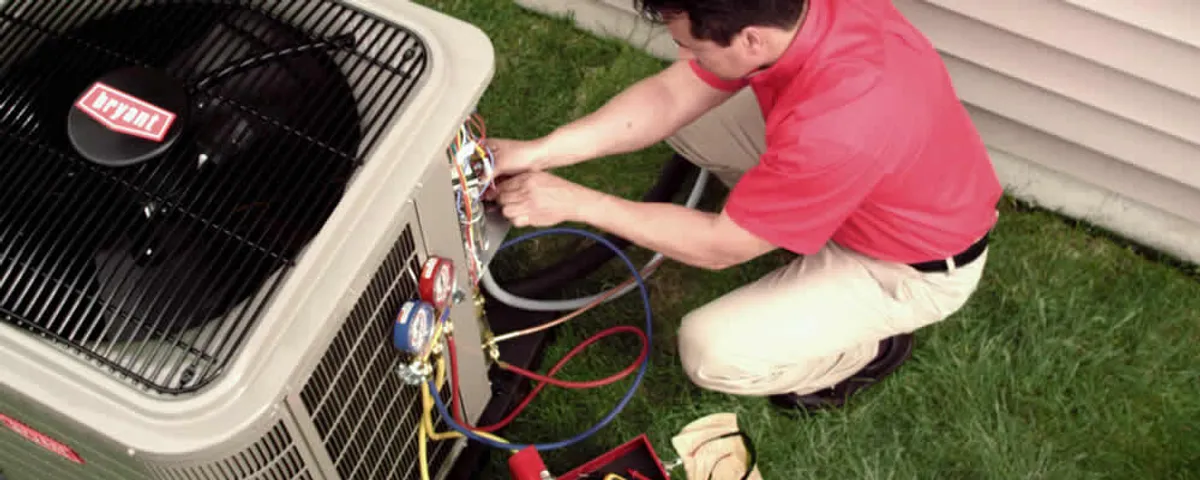 HVAC technician servicing an outdoor air conditioner unit in Vancouver, WA