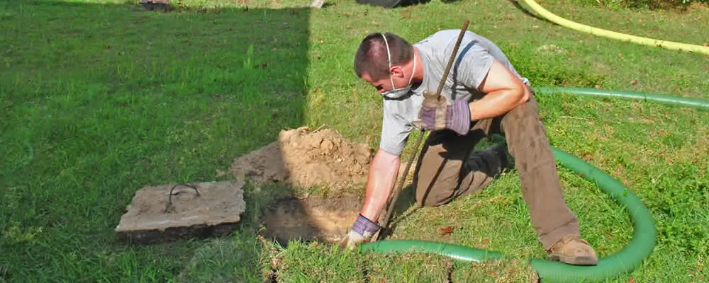 Septic pumping technician servicing a residential septic tank in Vancouver, WA