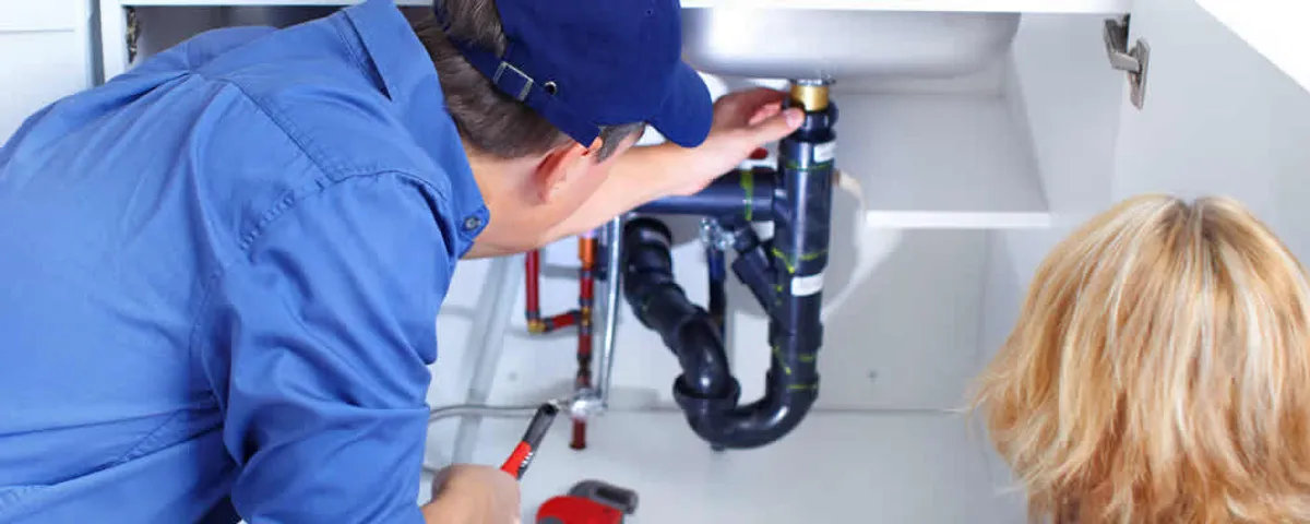 Plumber repairing under-sink drain pipes and fittings in Vancouver, WA